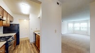 Located at 421 Lancaster Ave in Reynoldsburg, Ohio, this single-floor residence offers a practical and comfortable layout with well-defined living spaces throughout. The open living area is finished with neutral-toned carpet and connects seamlessly to the kitchen via a pass-through counter, making the space feel connected and functional. A ceiling fan adds comfort to the living area, which also features a closet for added storage.

The galley-style kitchen is equipped with warm wood cabinetry, granite-style countertops, and black appliances including a gas range, refrigerator, and dishwasher. Wood-look vinyl flooring runs through the kitchen, lending a clean, durable finish. A louvered closet door in the kitchen area provides additional pantry or utility storage.

The bedrooms are carpeted and filled with natural light from large windows with blinds. One bedroom features a charming bay window arrangement, creating an inviting alcove. Both rooms offer ample wall space and closet access.

The bathrooms are finished with wood-look flooring, granite-style countertops, warm wood vanity cabinetry, and full tub-shower combinations. A textured ceiling is present in several rooms, adding a classic residential character throughout the home. Overall, the space presents a clean, move-in ready environment with consistent finishes across all rooms.