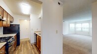 Located at 421 Lancaster Ave in Reynoldsburg, Ohio, this single-floor residence offers a practical and comfortable layout with well-defined living spaces throughout. The open living area is finished with neutral-toned carpet and connects seamlessly to the kitchen via a pass-through counter, making the space feel connected and functional. A ceiling fan adds comfort to the living area, which also features a closet for added storage.

The galley-style kitchen is equipped with warm wood cabinetry, granite-style countertops, and black appliances including a gas range, refrigerator, and dishwasher. Wood-look vinyl flooring runs through the kitchen, lending a clean, durable finish. A louvered closet door in the kitchen area provides additional pantry or utility storage.

The bedrooms are carpeted and filled with natural light from large windows with blinds. One bedroom features a charming bay window arrangement, creating an inviting alcove. Both rooms offer ample wall space and closet access.

The bathrooms are finished with wood-look flooring, granite-style countertops, warm wood vanity cabinetry, and full tub-shower combinations. A textured ceiling is present in several rooms, adding a classic residential character throughout the home. Overall, the space presents a clean, move-in ready environment with consistent finishes across all rooms.