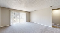 Located at 321 Imperial Blvd in Lakeland, Florida, this single-story home offers four bedrooms and two bathrooms across a well-organized floor plan. The living room is a bright, welcoming space featuring soft carpeting, neutral-toned walls, a textured ceiling, and large sliding glass doors fitted with vertical blinds that frame views of an outdoor pool and lush Florida landscaping — bringing in abundant natural light.

The kitchen is thoughtfully appointed with white cabinetry, granite-patterned countertops, a stainless steel sink, and wood-look flooring. A window above the sink allows natural light to fill the space, which also includes a dishwasher and electric range.

Each of the four bedrooms is carpeted and features ceiling fans for comfort. The primary bedroom includes a sliding closet with built-in shelving and rod storage, along with a window providing natural light. The remaining bedrooms are similarly sized, each with neutral walls and ceiling fans.

The two bathrooms are cleanly finished with white vanities, white countertops, and wood-look tile flooring. One bathroom features a full tub-shower combination with white tile surround, while the other includes a single vanity with a framed mirror. Both offer a clean, functional aesthetic throughout.