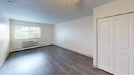 Located at 600 S Horner St in Lebanon, Illinois, this 2-bedroom, 1-bathroom unit offers a practical and well-organized single-floor layout. The living area features wood-style laminate flooring in a warm gray tone, white walls, and a ceiling fan, creating a clean and neutral environment. A window with blinds allows natural light to fill the room, while a wall-mounted HVAC unit and baseboard heating provide year-round climate control.

The kitchen is laid out in a galley style, featuring light wood cabinetry, dark laminate countertops, a stainless steel sink, and overhead track lighting. A full-size refrigerator is included, and upper cabinets provide ample storage space.

The spacious primary bedroom includes a double-door closet and access to additional rooms, with the same wood-style flooring continuing throughout. The second bedroom benefits from a window overlooking greenery outside, with baseboard heating along the wall.

The bathroom is equipped with a full soaking tub and shower combination, a handheld showerhead, and stainless steel grab bars, making the space both functional and accessible. The overall design of the unit is clean and straightforward, with a neutral color palette that offers a versatile canvas for personalization.