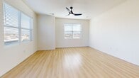 Located at 2211 Rio Grande Blvd NW in Albuquerque, New Mexico, this well-appointed one-bedroom, one-bathroom unit offers a thoughtfully designed open-concept floor plan with a clean, contemporary aesthetic. Light wood flooring runs throughout, complementing the bright white walls and recessed lighting that create a warm, airy atmosphere.

The combined living, dining, and kitchen area forms the heart of the unit. The kitchen is outfitted with white shaker-style cabinetry, granite countertops, stainless steel appliances including a range, microwave, and French door refrigerator, and a peninsula that provides additional prep and seating space. Large windows flood the living area with natural light, and a ceiling fan adds comfort and style. Sliding glass doors open onto one of two private balconies, offering outdoor views of the surrounding Albuquerque neighborhood.

The bedroom is a comfortable, well-lit space featuring a ceiling fan, a sliding glass door to a second balcony, and a closet with sliding panel doors. The full bathroom includes a white vanity with storage, a soaking tub, and wood-look flooring. A dedicated laundry area with hookups provides added convenience. The unit also features a solid wood entry door, completing its modern and functional design.