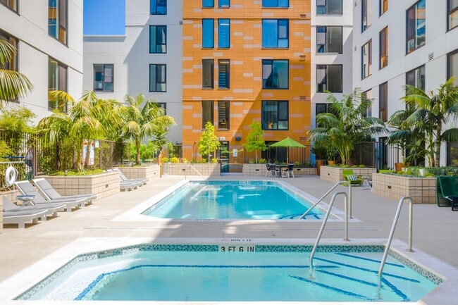Dive into everyday luxury with this sunny courtyard pool. - MacArthur Commons