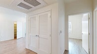 Located in Chula Vista, CA, this single-floor residence offers four bedrooms and two full bathrooms within a clean, modern layout. Throughout the home, warm wood-look flooring creates a cohesive and inviting aesthetic, while crisp white walls and neutral tones lend a bright, airy feel to every room.

The kitchen is designed for functionality, featuring ample white cabinetry extending to the ceiling for generous storage, a full suite of white appliances including a range, dishwasher, and refrigerator, and a double-basin sink. An open connection to the adjacent living area enhances the flow of the space.

Each of the four bedrooms is finished with the same wood-look flooring and neutral walls, offering a clean canvas for personalization. The primary bedroom provides a comfortable footprint with access to natural light via a window with blinds. Several bedrooms feature ceiling vents for climate control. Double louvered doors in the hallway provide access to an interior storage closet, adding practical utility to the layout.

The two full bathrooms are identically appointed with white vanities, large mirrors, and full tub-shower combinations featuring curved curtain rods and tiled surrounds — all in a clean, minimalist style. Hallways connect the rooms efficiently, contributing to a well-organized and functional floor plan throughout.