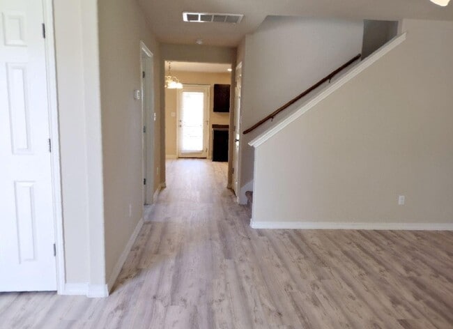 Hallway to the kitchen. Half a bath to the left and Storage Closet under the stairs - 126 Preston Trl
