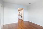 Located at 221 Cherry St S in Winston-Salem, NC, this single-floor unit offers a clean, modern aesthetic throughout. Warm hardwood flooring runs continuously across the main living and bedroom areas, providing a cohesive look and feel that enhances the sense of openness.

The living area is bright and airy, benefiting from large windows and a glass door that opens to a balcony, framing views of the surrounding cityscape and allowing natural light to fill the space. An adjacent room mirrors this layout, also featuring a glass door with outdoor access and ample natural light.

The kitchen is well-appointed with white shaker-style cabinetry, granite countertops, and stainless steel appliances including a range, dishwasher, and refrigerator, along with a ventilation hood above the stove.

Two full bathrooms serve the unit. One features light tile flooring, a tub-shower combination, and built-in shelving, while the second offers a modern vanity with frosted-glass cabinet doors, a well-lit mirror, and tile flooring. Additional storage is provided by a dedicated closet space with built-in shelving. The overall ambiance is clean, neutral, and move-in ready.