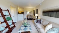 This single-floor residence offers a thoughtfully designed open-concept layout that seamlessly connects the living, dining, and kitchen areas. The living room is anchored by a tile-surround fireplace and features plush carpeting, a large sliding glass door, and direct access to a private balcony with tree-lined views, filling the space with natural light.

The galley-style kitchen is well-equipped with light wood cabinetry, dark granite countertops, a mosaic tile backsplash, stainless steel appliances, and durable hardwood-style flooring. Adjacent to the kitchen, the dining area includes a built-in buffet niche with a decorative mirror and pendant lighting overhead, creating an intimate setting for entertaining.

The two bedrooms are carpeted and generously sized. One features a charming window seat with built-in shelving, while the other offers a large window with garden views. Both provide a calm, restful atmosphere.

The two bathrooms are finished with hardwood-style flooring, wood cabinetry, dark granite countertops, and tiled shower-tub combinations, maintaining a consistent, cohesive aesthetic throughout the residence.