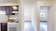 Located at 1600 Garrett Rd in Upper Darby, PA, this one-bedroom, one-bathroom residence offers a thoughtfully arranged single-floor layout that maximizes every square foot. Light hardwood-style flooring runs throughout the main living areas, complemented by neutral white walls and textured ceilings that create a clean, consistent aesthetic.

The galley-style kitchen is a functional highlight, featuring rich dark espresso cabinetry with generous upper and lower storage, granite-look countertops, a stainless steel sink, a gas range, and a full-size refrigerator. A central hallway connects the kitchen to the rest of the unit, offering a natural flow between spaces.

The living room and dedicated dining area are bathed in natural light from multiple windows, giving the common areas an open, airy feel. Baseboard heating is present throughout, ensuring year-round comfort.

The bedroom is a comfortable, well-proportioned retreat with a large window overlooking greenery, hardwood-style floors, and a full-panel bifold closet. Three closets in total provide excellent storage throughout the unit.

The bathroom is finished with white tile wainscoting, a dark vanity with a white countertop, a mirrored medicine cabinet, and overhead vanity lighting. The layout is efficient and well-appointed. This unit offers practical, comfortable living in a convenient Upper Darby location.