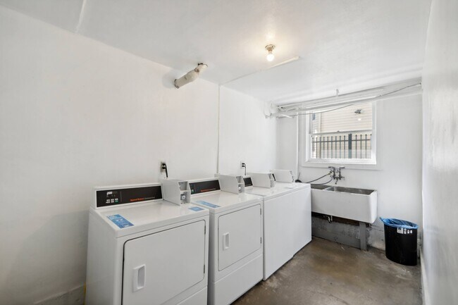 Laundry room with washes and dryers and a sink and a window - 2410 Dwight Way
