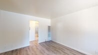 Located at 1158 Sunnyvale-Saratoga Rd in Sunnyvale, California, this single-floor unit offers a clean, functional layout designed for comfortable everyday living. Throughout the space, light-toned vinyl plank flooring provides a cohesive and low-maintenance foundation that extends from the living areas into the bedrooms.

The main living area is bright and open, featuring crisp white walls, a wall-mounted heating unit, and a front entry door flanked by a window fitted with vertical blinds that allow natural light to filter in. A dedicated bedroom area is fitted with a ceiling fan and light fixture, along with a window offering views of the surrounding neighborhood.

The galley-style kitchen is a standout feature, showcasing a bold two-tone cabinet design with navy lower cabinets and lighter upper cabinets, complemented by a white quartz countertop, a single-basin sink, a tile backsplash, and full-size appliances including a refrigerator and oven range.

The bathroom includes a full tub and shower combination enclosed by a sliding glass door, with neutral tile surround featuring decorative accent tile detail, and a small window providing ventilation and natural light. The overall ambiance of the space is clean, understated, and move-in ready, situated in a convenient Sunnyvale location.