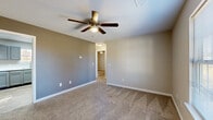 Located at 609 Landers St in Shelbyville, Tennessee, this single-floor, 2-bedroom, 1-bathroom home offers a practical and comfortable layout. The living room features neutral-toned walls, plush carpeting, and a ceiling fan with a light fixture, creating a warm and inviting atmosphere. Adjacent to the living area, the kitchen is well-appointed with gray cabinetry, white countertops, wood-look vinyl flooring, and white appliances including a range, microwave, and refrigerator. A window allows natural light to brighten the space. Both bedrooms are carpeted and equipped with ceiling fans; the second bedroom includes a window with outdoor views, while the primary bedroom offers generous proportions and multiple closets for ample storage. The full bathroom features wood-look flooring, a gray vanity with a marbled countertop, and a tub-shower combo. A dedicated utility room houses the water heater and provides additional functional space. With four closets distributed throughout the home, storage is plentiful. The consistent use of neutral tones, modern gray finishes, and wood-look flooring in shared areas gives the home a cohesive and updated aesthetic throughout.