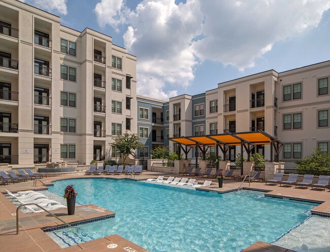 Pool with in-water lounge seats, additional lounge chairs, fountain and covered area - Elle of Buckhead