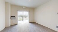 Located at 5708 S Spotted Rd in Spokane, WA, this one-bedroom apartment offers a well-organized, efficiently designed layout across a single floor. The living room is carpeted and bathed in natural light from a sliding glass door that opens to a private balcony, providing pleasant outdoor views of the surrounding landscape. A wall-mounted HVAC unit ensures year-round comfort in the living area.

The kitchen is a standout feature, outfitted with dark cabinetry, stainless steel appliances including a refrigerator, range, and microwave, and a peninsula counter with light-toned countertops. Light wood-style flooring in the kitchen contrasts neatly with the carpet in the adjoining living and bedroom areas.

The bedroom is a comfortable, well-proportioned space with soft carpet flooring, a large window that invites natural light and outdoor views, and a sliding closet that provides ample storage. The neutral, warm color palette throughout the unit lends a clean and cohesive ambiance.

A dedicated laundry room houses a full-size GE washer and dryer, adding a practical convenience rarely found in similarly sized units. The entry area features hard flooring and provides a clear transition point into the main living spaces. Overall, the unit presents a functional and modern living environment.
