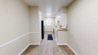 This 680 square foot apartment in Raleigh, NC, offers a well-designed living space with two bedrooms and two bathrooms. The unit features a modern kitchen with white cabinetry, black appliances, and a practical layout. The primary bedroom, measuring 210 square feet, provides ample space and includes an en-suite bathroom. Both bedrooms are equipped with ceiling fans and large windows for natural light. The bathrooms showcase updated fixtures and finishes, with one featuring a bathtub-shower combination. Throughout the apartment, you'll find a mix of wood-look vinyl flooring in the main living areas and plush carpeting in the bedrooms. The neutral color palette and clean lines create a contemporary feel. A hallway and closet space offer additional storage options. The apartment's efficient design maximizes the use of space, making it an ideal choice for those seeking a compact yet comfortable living environment in a prime Raleigh location.