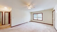 Located at 1949 Western Ave in Albany, NY, this two-bedroom, one-bathroom single-floor residence offers a practical and comfortable layout with a well-utilized floor plan. Neutral-toned carpeting flows throughout the living spaces, complemented by rich dark wood baseboards and door trim that add a warm contrast to the light-colored walls.

The spacious primary bedroom is a standout feature, offering generous square footage, two large closets with paneled sliding doors, a ceiling fan with light fixture, and a sliding glass door leading to an outdoor balcony or patio area. The second bedroom also includes a ceiling fan, a closet, and a window that brings in natural light. Both rooms provide a calm, comfortable atmosphere.

The full bathroom is equipped with a tub-shower combination featuring multiple stainless steel grab bars, making it both functional and accessible. The kitchen includes standard appliances and connects to the living and dining areas, with a sliding door providing access to the outdoors. A dedicated laundry area adds everyday convenience.

Throughout the unit, an impressive six closets provide exceptional storage capacity. A central hallway connects the main rooms, creating a cohesive and easy-to-navigate layout. Ceiling fans in each bedroom and the living area ensure year-round comfort in this well-appointed Albany residence.