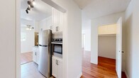 Located in the heart of Los Angeles, this 2-bedroom, 2-bathroom residence on South Almont Drive offers a thoughtfully designed single-level layout with a bright, cohesive aesthetic throughout. Warm hardwood flooring flows seamlessly across the living areas and bedrooms, complemented by clean white walls and textured ceilings that add character to each room. The kitchen is well-appointed with white shaker cabinetry reaching to the ceiling, stainless steel appliances including a refrigerator and built-in wall oven, and tile flooring, blending functionality with a modern finish. It opens conveniently toward the dining and living areas, creating a connected, open feel. The living room is generously proportioned, filled with natural light from large windows and a sliding glass door that leads to a private balcony, offering a seamless indoor-outdoor connection. A ceiling fan adds comfort to the space. Both bedrooms are well-sized, with the primary bedroom featuring direct access to a dedicated closet and en-suite bathroom. Bedrooms include mirrored sliding closet doors that enhance the sense of space. The bathrooms are clean and functional, featuring tile flooring, white vanity cabinetry with granite-style countertops, and a shower-tub combination. With five closets total spread throughout the home, storage is plentiful.