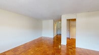 Located on the fourth floor at 34 Medfield St in Boston's Fenway neighborhood, this studio unit offers a well-organized single-floor layout comprising a living area, kitchen, bathroom, and closet. The living space is bright and open, featuring warm parquet wood flooring in a classic block pattern that runs throughout. Large floor-to-ceiling windows with roller shades flood the room with natural light while framing views of the surrounding Boston cityscape. A built-in heating unit sits beneath the windows, providing efficient climate control.

The kitchen is neatly appointed with white cabinetry, light stone countertops, a stainless steel sink, and a mosaic tile backsplash in neutral tones. A full-size refrigerator and ample cabinet storage make the space highly functional despite its compact footprint.

The bathroom features classic white subway tile walls with contrasting black tile accents, a combination tub and shower with a grab bar, mosaic tile flooring, and a white vanity with under-sink storage topped by a large mirror.

A dedicated closet with built-in shelving and hanging rods provides organized storage. The unit's clean white walls, consistent flooring, and thoughtful layout create a cohesive and functional living environment well-suited for city living in Boston.