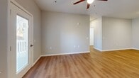 Located at 2747 Kelly Lake Rd in Decatur, GA, this single-story, 4-bedroom, 1-bathroom home offers a well-designed layout with modern finishes throughout. Light wood-style flooring runs continuously across the space, complementing the neutral gray walls and crisp white trim.

The heart of the home is an open-concept living, dining, and kitchen area. The kitchen is outfitted with dark espresso cabinetry, granite-style countertops, stainless steel appliances—including a range, microwave, and refrigerator—and a central island with a sink, providing both prep space and a natural gathering point. Recessed lighting illuminates the area, while the adjacent living room features a ceiling fan and access to natural light through windows and a glass door.

A hallway connects the common areas to the four bedrooms, each finished with the same wood-style flooring and equipped with ceiling fans. The primary bedroom offers generous proportions and direct access to the shared bathroom. The bathroom features a dark vanity with granite countertops, a tub-shower combination, and built-in shelving for storage.

Additional practical spaces include a dedicated laundry room with washer and dryer hookups, a utility room, four closets, and an entrance foyer, making this a highly functional and move-in-ready home.