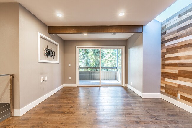Living room with access to patio, wall mount for up to 50" TV is provided - 10911 NE 37th Pl