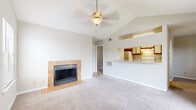 Located at 1615 Hunnington Pl in Hurstbourne Acres, Kentucky, this single-floor residence offers a well-organized layout with a variety of practical and comfortable features throughout.

The living area serves as the centerpiece of the home, showcasing vaulted ceilings that enhance the sense of openness. A ceiling fan with a light fixture provides both comfort and illumination. A wood-burning fireplace framed by a tile surround and hearth adds a focal point to the room, while plush wall-to-wall carpeting contributes to a warm atmosphere. A pass-through opening connects the living area directly to the kitchen, promoting an open and connected feel.

The kitchen is equipped with white appliances, including a coil-burner range with an overhead ventilation hood, dishwasher, and refrigerator. Wood-trimmed cabinetry with white doors offers ample storage, and light-toned countertops provide functional workspace. Tile flooring runs throughout the kitchen and extends into a pantry closet nearby.

The bedrooms feature carpeted floors and ceiling fans. One bedroom includes a mirrored sliding-door closet with built-in shelving, while another opens to a private balcony through a sliding glass door, offering outdoor views. In-unit laundry hookups are conveniently accessible from the bedroom area.

The bathroom includes a full tub and shower combination with white tile surround accented by a beige border, tile flooring, and a wide vanity with wood-trimmed cabinetry.