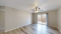 Located at 2981 Sundance Cir in Las Cruces, NM, this well-designed single-story, one-bedroom, one-bathroom home makes smart use of its compact footprint. Light wood-look flooring runs consistently throughout the entire space, lending a clean, cohesive aesthetic from room to room.

The living room is bright and open, featuring a ceiling fan with light fixture and a full-width sliding glass door that fills the room with natural light and provides direct access to a private outdoor patio area. The combined dining and kitchen area showcases a galley-style layout with gray shaker cabinetry, white subway tile backsplash, quartz-style countertops, a stainless steel sink, and black appliances including a refrigerator and range. A skylight overhead adds additional natural illumination to the kitchen.

The bedroom is a comfortable size, offering its own ceiling fan, a window for natural light, and access to multiple closets, providing ample storage. The full bathroom features a tub/shower combo, toilet, and towel bars, finished in a clean, all-white palette. A dedicated laundry area and an accessible electrical panel are also incorporated into the layout. A hallway connects the private areas of the home, completing this efficient and move-in-ready residence.