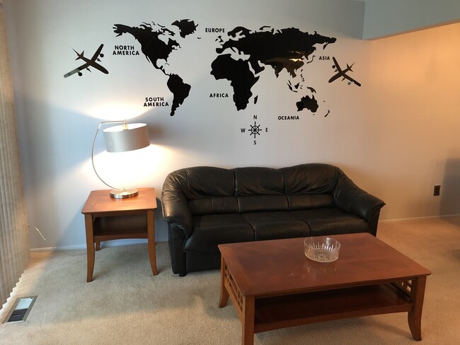 Comfortable living room features leather sofa and coffee table. - 8328 Karam Blvd