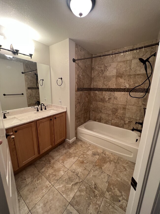 Double sink and tub shower - 15234 W 63rd Ave Apartment