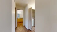Located in Airway Heights, WA, this 2-bedroom, 1-bathroom unit offers a practical and comfortable single-floor layout. The living room serves as the heart of the home, featuring a fireplace, plush carpeting, and a sliding glass door that opens to a private balcony with views of the surrounding neighborhood. A large window allows natural light to fill the space. Adjacent to the living area, the dining room and kitchen are designed for everyday functionality. The kitchen is fully equipped with light wood cabinetry, ample counter space, a range, dishwasher, refrigerator, and wood-look vinyl flooring. Both bedrooms are carpeted and well-lit; the primary bedroom offers a comfortable footprint, while the second bedroom features a window with neighborhood views. The shared bathroom includes a wood-toned vanity with storage, a large mirror with overhead lighting, and a shower with a curtain surround, all finished with wood-look flooring. A utility room with a stacked washer and dryer adds everyday convenience. Throughout the unit, a neutral color palette and clean finishes create a bright and cohesive atmosphere.