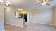 Located at 10558 Eastern Shore Blvd in Spanish Fort, Alabama, this two-story residence offers 2 bedrooms, 3 bathrooms, and a thoughtful layout spread across two floors. The ground level houses an attached garage with automatic door access, along with a carpeted staircase leading to the main living areas above.

The upper floor serves as the heart of the home. The open-concept living area features light hardwood-style flooring, crown molding, and a ceiling fan, creating a bright and comfortable atmosphere. The kitchen is well-appointed with warm wood cabinetry, granite-style countertops, tile flooring, and black stainless steel appliances including a refrigerator, range, microwave, and dishwasher. A peninsula with seating connects the kitchen to the living space.

The spacious primary bedroom includes plush carpet, a ceiling fan, a window with natural light, and access to a generously sized walk-in closet with wire shelving. The bathrooms feature granite-topped vanities, tile flooring, and tub-shower combinations with tile surround. A dedicated laundry area with wire shelving accommodates a full-size washer and provides additional storage. The second bedroom also features carpet flooring, a ceiling fan, and a bright window, making it a comfortable and functional space.