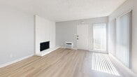 This contemporary 830 square foot apartment in Garden Grove, CA offers a blend of style and functionality. The space features two bedrooms, including a primary bedroom of 180 square feet, and two bathrooms. The single-story layout maximizes living space with an open-concept design.

The kitchen is a highlight, showcasing a galley-style layout with sleek white cabinetry, quartz countertops, and stainless steel appliances. A decorative tile backsplash adds a touch of elegance. The kitchen opens to a bright living area, creating a seamless flow for entertaining.

Both bedrooms are generously sized, with the primary bedroom offering ample space. Neutral-toned carpeting in the bedrooms provides comfort underfoot. Large windows in each room allow for plenty of natural light, enhancing the airy feel of the space.

The bathrooms feature modern fixtures, including floating vanities and glass-enclosed showers. Light wood-look flooring throughout the main living areas adds warmth and complements the overall contemporary aesthetic.

A standout feature is the abundance of natural light, thanks to multiple windows and sliding glass doors that lead to outdoor spaces. The living room boasts a cozy fireplace, perfect for chilly evenings. Overall, this apartment offers a fresh, modern living experience with its updated finishes and thoughtful design.