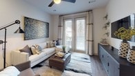 Located in Franklin, Tennessee, this single-floor residence at 145 Legends Club Ln offers a thoughtfully designed layout with contemporary finishes and a cohesive aesthetic throughout. The kitchen serves as a functional centerpiece, featuring white shaker cabinetry, stainless steel appliances, a subway tile backsplash with under-cabinet lighting, and a central island with a quartz-style countertop and bar seating — ideal for both cooking and casual dining. Hardwood-style flooring runs through the kitchen and main living areas, adding warmth and continuity.

The living room is bright and comfortable, benefiting from large windows and a glass door that allow natural light to fill the space. A ceiling fan, neutral palette, and tasteful décor contribute to a relaxed yet refined atmosphere.

The bedroom is a well-appointed retreat, featuring plush carpeting, generous natural light from double windows with draping curtains, and ample wall space for art. The adjoining bathroom includes a single-sink vanity with quartz countertops, wood-look flooring, a tub-shower combination, and direct access to a walk-in closet with built-in organization. The overall ambiance of the residence is modern, curated, and move-in ready.