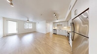 Located at 1545 Wigwam Parkway in Henderson, NV, this 2-bedroom, 1-bathroom residence offers a thoughtfully designed open-concept layout that seamlessly connects the living room, dining area, and kitchen into one bright, cohesive space. Light wood-style flooring flows throughout the main living areas, complemented by crisp white walls and abundant natural light from large windows.

The kitchen is equipped with stainless steel appliances — including a refrigerator, range, microwave, and dishwasher — paired with white shaker-style cabinetry, a subway tile backsplash, and light countertops. Track lighting adds a modern touch overhead. A ceiling fan in the living area enhances comfort, while a patio provides additional outdoor living space.

Both bedrooms offer plush carpeting and natural light through windowed blinds. The primary bedroom connects to a spacious walk-in closet featuring dual hanging rods and built-in shelving. Additional closets throughout provide generous storage. The bathroom is clean and modern, featuring a tub/shower combination, a single vanity with white cabinetry, and wood-style flooring. An in-unit laundry area and a connecting hallway complete this efficient and comfortable home.