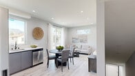 Located at 13615 Fellows Ave in Sylmar, Los Angeles, this contemporary three-story home offers four bedrooms, three bathrooms, and a thoughtfully designed layout spread across three levels. The entry level provides a compact yet functional footprint, while the two upper floors deliver the majority of the living space.

The main living floor features an open-concept kitchen and living room bathed in natural light. The kitchen is appointed with sleek grey cabinetry, white quartz countertops, stainless steel appliances, a matte black faucet, and a picture window framing picturesque mountain views. The adjoining dining and living areas flow seamlessly, with light hardwood-style flooring and recessed lighting throughout creating a bright, cohesive atmosphere.

Each of the four bedrooms is finished with the same light flooring and neutral palette, offering a calm and restful environment. Bedrooms feature mirrored sliding closets, high clerestory windows for added light and privacy, and sliding glass doors opening to private balconies. The primary bedroom provides a comfortable, well-proportioned retreat.

The three bathrooms are clean and modern, featuring floating grey vanities, framed mirrors, and glass-enclosed tub-shower combinations with white tile surround. A dedicated laundry area and multiple hallways and staircases ensure practical circulation throughout all three floors. Three balconies offer outdoor access and views across the neighborhood.