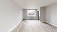 Located at 2307 Lake Shore Blvd W in Toronto's sought-after lakeshore neighbourhood, this thoughtfully renovated one-bedroom, one-bathroom unit offers a clean, modern aesthetic throughout. Light-toned laminate flooring runs seamlessly across the entire space, complemented by crisp white trim and neutral grey walls that create a bright, airy atmosphere.

The open-concept living and dining area is generously proportioned, anchored by multiple windows that invite natural light from multiple directions. Radiant baseboard heaters line the walls, ensuring year-round comfort. The kitchen is efficiently designed, featuring dark espresso cabinetry with a tile backsplash, stainless steel appliances including a refrigerator and range, and a window that adds ventilation and additional light.

The bedroom is a comfortable and well-lit retreat, featuring a large window with an outdoor view, a mirrored sliding closet, and radiant heating. Additional closet space is thoughtfully distributed throughout the unit, including near the entrance and hallway, offering ample storage.

The bathroom is a standout feature, finished with elegant large-format marble-look porcelain tiles on both the floor and full-height tub surround, a soaking tub, and a bright window. The entrance and hallway provide a welcoming transition into the home. Overall, this unit presents a polished, move-in-ready living experience.