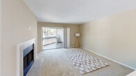Located at 4550 47th St W in Bradenton, Florida, this single-floor, 3-bedroom, 2-bathroom residence offers a functional and comfortable layout. The combined living and dining area serves as the heart of the home, featuring a tile-surround fireplace with built-in shelving alongside it — a standout architectural detail. Sliding glass doors open to a private balcony with views of surrounding palm trees and greenery, filling the living space with natural light. A chandelier accents the dining area, complementing the wood-look flooring at the entry. The bedrooms are carpeted and equipped with ceiling fans, providing comfort throughout. Two of the bedrooms offer windows with lush outdoor views, while the spacious primary bedroom features direct access to its en-suite bathroom, which is appointed with a granite-style countertop, an extended vanity with white cabinetry, and a shower-tub combination. The second full bathroom mirrors a similar clean aesthetic. The kitchen connects directly to one of the secondary bedrooms and features white cabinetry and a functional workspace. Neutral warm-toned walls and consistent finishes throughout give the home a cohesive, move-in ready feel well-suited for Florida living.