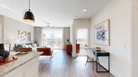 This well-appointed 2-bedroom, 2-bathroom residence in Austin, TX (78717) offers a thoughtfully designed open-concept layout across a single floor. Wood-style plank flooring flows throughout the main living areas, anchoring a bright and cohesive aesthetic. The kitchen is a standout feature, showcasing granite countertops, sleek taupe cabinetry, stainless steel appliances, a subway tile backsplash, and a pendant light fixture — all oriented toward the open living and dining area for effortless entertaining. The living room is bathed in natural light through large sliding glass doors that open to a private balcony, offering outdoor views of the surrounding neighborhood. A ceiling fan adds comfort overhead. The primary bedroom is a comfortable retreat featuring plush carpeting, a ceiling fan, large windows with ample natural light, and access to a well-sized walk-in closet. The primary bathroom features granite-topped dual vanities with white cabinetry, wood-style flooring, and a spacious walk-in closet with built-in shelving. Four closets total are distributed throughout the residence, providing generous storage. The neutral color palette, modern finishes, and abundance of natural light throughout create a clean, contemporary ambiance suited for comfortable everyday living.