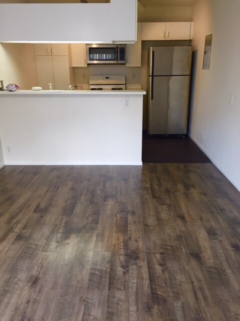 combined kitchen and living room. new flooring throughout and new stainless fridge. - 91 -214 Hanapouli Cir