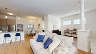 Located at 1000 Cherry Hill Rd in Cohoes, NY, this two-story home offers 3 bedrooms, 2 bathrooms, and a well-designed layout spread across two floors. The main level features a bright, open-concept living, dining, and kitchen area finished with warm light oak hardwood flooring throughout. The living room is filled with natural light from large windows and offers a welcoming, comfortable atmosphere. The dining area is accented by a chandelier and features elevated ceilings that add a sense of spaciousness. The kitchen is well-appointed with light wood cabinetry, granite countertops, a white subway tile backsplash, and stainless steel appliances, including a range and over-the-range microwave. Upstairs, three bedrooms provide ample living space, including a generously sized primary bedroom with a sliding door closet and plush carpeting. The two bathrooms are finished with granite-topped vanities, dual sinks, and hardwood-style flooring. A dedicated laundry room with a top-load washer adds everyday convenience. The home also includes an attached single-car garage with a concrete floor. Two hallways, two staircases, and multiple closets round out the functional and thoughtfully organized floor plan.