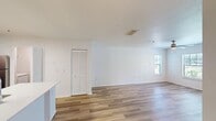 This 790 square foot apartment at MacAlpine Place offers a thoughtfully designed living space on a single floor. The unit features one bedroom measuring 150 square feet, providing a cozy retreat. The open-concept layout seamlessly blends the kitchen and living room, maximizing the use of space and creating an airy atmosphere.

The modern kitchen is equipped with stainless steel appliances, including a refrigerator and built-in microwave. It boasts ample counter space with a sleek white countertop and a functional island, perfect for meal preparation or casual dining. The living area is spacious and versatile, with room for various furniture arrangements.

Throughout the apartment, warm wooden flooring adds a touch of elegance and continuity. The bathroom is efficiently designed with a white vanity, providing storage space, and a shower-tub combination. Large windows in the bedroom and living area allow natural light to flood the space, while ceiling fans ensure comfortable air circulation.

Storage solutions are abundant, with a walk-in closet and additional built-in shelving. The neutral color palette of white walls and ceilings creates a blank canvas for personalization. This apartment is ideal for those seeking a compact yet well-appointed living space that combines functionality with modern aesthetics.