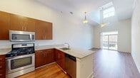 Located at 45 Meadowlands Pkwy in Secaucus, NJ, this well-appointed one-bedroom, one-bathroom residence offers a thoughtfully designed layout across a single floor. Soaring ceilings throughout create an open, airy atmosphere that enhances the sense of space.

The combined kitchen and living area serves as the heart of the home. Rich hardwood flooring flows throughout, complementing the clean, neutral-toned walls. The kitchen is outfitted with warm wood cabinetry, granite countertops, stainless steel appliances including a gas range, microwave, refrigerator, and dishwasher, making it both functional and stylish. A sliding glass door in the living area opens to a private balcony, filling the space with natural light and offering views of the surrounding area.

The bedroom is a comfortable retreat featuring plush carpeting, a ceiling fan, and a window that brings in additional natural light. A dedicated closet provides convenient storage.

The bathroom is elegantly finished with rich wood vanity cabinetry, dark granite countertops, a large mirror, and a tiled shower-tub combination with tasteful stone-look tile surround. The residence also includes an entry foyer with hardwood flooring that connects seamlessly to the main living areas.