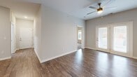 Located at 2239 Charlestown Rd in New Albany, Indiana, this thoughtfully designed two-bedroom, two-bathroom residence offers comfortable single-level living. The open-concept layout seamlessly connects the living room, dining area, and kitchen, all finished with rich hardwood-style flooring. The kitchen is well-appointed with white shaker cabinetry, granite-look countertops, and a full suite of stainless steel appliances including a range, dishwasher, and refrigerator, complemented by recessed lighting overhead. The living room features a ceiling fan and access to a private exterior door with a windowed panel that invites natural light. Both bedrooms are carpeted for comfort and include ceiling fans or windows that bring in natural light and outdoor views. The spacious primary bedroom offers its own closet, while the unit includes a total of four closets providing ample storage throughout. The two bathrooms are finished with wood-style flooring, clean white fixtures, and modern vanities; one bathroom features accessibility-friendly grab bars and a floating sink. A dedicated laundry room with hookups adds everyday convenience. The neutral color palette and clean finishes throughout create a bright, move-in-ready atmosphere.