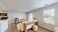 Located at 700 Vista Dr in Gahanna, Ohio, this well-appointed one-bedroom, one-bathroom residence offers a thoughtfully designed single-level layout that maximizes every square foot. Neutral gray walls and light hardwood-style flooring run throughout the main living areas, creating a cohesive, airy aesthetic. The living room is bright and welcoming, benefiting from multiple windows that draw in natural light and sliding glass door access, providing a seamless connection to the outdoors. Recessed lighting adds a polished finish to the space. The kitchen is efficiently arranged with white cabinetry, quartz countertops, and black appliances including a gas range, over-the-range microwave, and refrigerator. A peninsula countertop offers additional prep space. Conveniently situated off the kitchen, the laundry area and a dedicated utility/storage room with built-in shelving provide practical functionality. The generously sized bedroom is carpeted for comfort and features two sliding-door closets, offering ample storage. A window frames a pleasant outdoor view, filling the room with soft natural light. The bathroom is clean and functional, equipped with a full soaking tub and shower combination with chrome fixtures. This residence delivers a comfortable and practical living experience in a serene Gahanna setting.