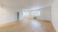 Located at 5330 Corteen in the Valley Village neighborhood of Los Angeles, this 2-bedroom, 1-bathroom residence offers a clean, modern aesthetic across a single-floor layout. Light-toned hardwood-style flooring runs throughout the entire unit, creating a cohesive and bright feel from room to room.

The open living room is generously proportioned, featuring a textured ceiling, a wall-mounted heater, a window A/C unit, and large windows fitted with blinds that allow abundant natural light to fill the space. A ceiling fan adds both functionality and style.

The kitchen is efficiently designed with white cabinetry, a stainless steel sink, and a full-size refrigerator, providing ample storage and counter space for everyday use.

Both bedrooms are well-sized, each equipped with ceiling fans and windows that bring in natural light. The primary bedroom features a mirrored sliding closet and a smart home entry panel, while the second bedroom also includes a mirrored closet and an additional window for ventilation.

The bathroom is finished with neutral beige tile surrounding a full soaking tub and shower combo, complemented by light wood flooring, a white vanity, and chrome fixtures.

A connecting hallway ties the layout together, offering a practical flow between all living areas.