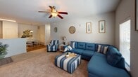 Located at 1821 Buckeye Dr in Richmond Hill, Georgia, this single-floor residence offers a thoughtfully designed layout that balances comfort and functionality. The kitchen is a standout space, featuring dark espresso cabinetry with ample storage, granite countertops, and a full suite of stainless steel appliances including a refrigerator, electric range, and built-in microwave. Light wood-look flooring grounds the kitchen and adjoining dining area, creating a warm, cohesive feel. The living room is generously proportioned, filled with natural light from multiple windows, and finished with soft wall-to-wall carpeting. A ceiling fan adds a practical touch to this inviting gathering space. The two bedrooms are well-sized, each featuring plush carpeting, bright windows with blinds, and ample room for full furniture arrangements. The primary bedroom benefits from multiple windows that allow abundant natural light to fill the space. Both bathrooms are clean and functional, finished with wood-look flooring, white vanities with drawer storage, and arched panel doors that add a refined architectural detail. The overall color palette throughout the home is neutral and light, creating a calm, cohesive ambiance from room to room.