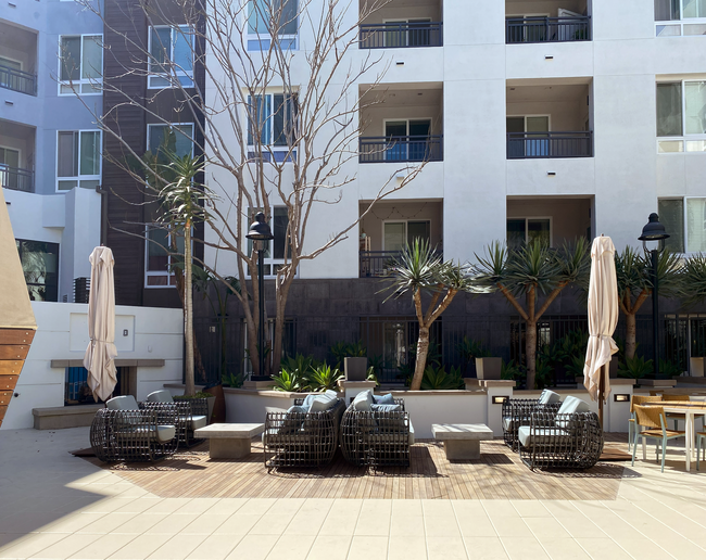 Pool Deck and Fireplace | Elan Huntington Beach | Apartments in Huntington Beach, CA - Elan Huntington Beach