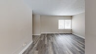 Located at 2071-2091 Belvoir in Cleveland, OH, this two-bedroom, one-bathroom unit offers a practical and well-organized single-floor layout. Throughout the space, grey vinyl plank flooring provides a cohesive, modern look that ties each room together seamlessly.

The living areas are bright and open, with large windows fitted with blinds that allow natural light to filter in. Neutral beige walls create a clean, versatile backdrop throughout. A hallway connects the main living spaces to the bedrooms, providing a clear and functional flow.

The kitchen features white cabinetry with ample upper and lower storage, dark marbled countertops, a stainless steel sink, a tile backsplash, and a gas range, offering everything needed for everyday cooking.

Both bedrooms are comfortably sized, each equipped with ceiling fans for year-round comfort. The primary bedroom includes a built-in closet with bifold doors, while the second bedroom also features closet storage. Windows in each bedroom bring in natural light and views of the surrounding neighborhood.

The bathroom is neatly appointed with a tub-shower combination, white tile surround, a vanity with sink, and a window for ventilation and natural light.

The entry area provides a welcoming transition into the home, complete with the same consistent flooring found throughout the unit.