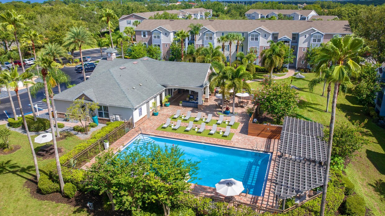 Experience the ultimate relaxation at Ashton Chase’s sparkling pool, complete with ample lounge seating and a beautifully shaded clubhouse. - Ashton Chase