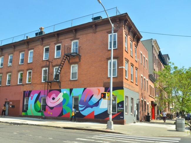 Mural on facade by Jason Naylor. - 246 Tompkins Ave