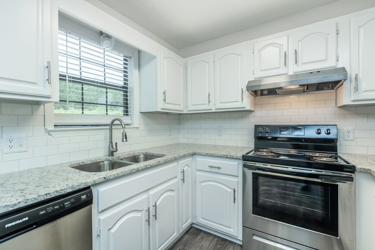 Gorgeous Granite Countertops with Modern Subway Tile Backsplash paired with White Cabinets - Woodland Manor