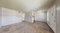 Located at 3409 North St in Nacogdoches, TX, this single-story, one-bedroom, one-bathroom home offers a well-organized and efficient layout. The entrance welcomes you into a bright, carpeted living room filled with natural light from two front-facing windows with blinds, creating a warm and inviting atmosphere. The living area transitions seamlessly into the dining room, where hardwood-style flooring begins and continues into the kitchen. The kitchen features a peninsula breakfast bar, white cabinetry, light granite-style countertops, and stainless steel appliances including a refrigerator and dishwasher. A hallway connects the main living areas to the private bedroom and bathroom. The bedroom is a comfortable, carpeted retreat equipped with a ceiling fan, a window overlooking a green outdoor view, and two closets offering ample storage. The bathroom is clean and functional, featuring a full tub-shower combo with white tile surround and hardwood-style flooring. Throughout the home, neutral tones and white trim create a cohesive, move-in-ready aesthetic. Two closets provide additional storage convenience, making this an ideal space for efficient, comfortable single-floor living.