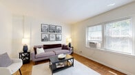 Located at 2907 North High Street in Columbus, OH, this one-bedroom, one-bathroom unit offers a well-organized and efficiently designed single-floor layout. The living room is warm and inviting, showcasing classic parquet hardwood flooring that extends throughout the main living areas. Natural light filters in through windows dressed with blinds, creating a bright and comfortable atmosphere. The space comfortably accommodates a seating area and additional accent chairs, offering a versatile layout for everyday living.

The kitchen features white cabinetry, a stainless steel sink, and black appliances, including a full-size refrigerator and range. A large window brings in natural light, enhancing the clean, functional design of the space. Tile flooring adds a practical touch to this well-equipped room.

The bedroom is a comfortable and spacious retreat, complete with parquet hardwood flooring, a ceiling fan, natural light from a window, and a closet for ample storage.

The bathroom is bright and clean, finished in white with a full bathtub and shower combination. A window above the tub allows natural light to fill the room, contributing to its airy feel. Overall, this unit offers a practical and charming living space in a convenient Columbus location.